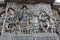 Hoysaleswara Temple Wall carved with sculpture of lord mahavishnu in between the sculptures of musician and dancer