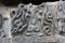 Hoysaleswara temple wall carved with sculpture of Prahlada surrounded by venomous snakes