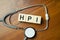 HPI word written on wooden blocks and stethoscope on light background. Healthcare conceptual for hospital, clinic and medical