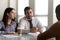 HR managers seated at desk in office interviewing African applicant