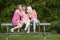 Hree young female friends seated on a bench, outdoors