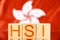 hsi index hong kong. wooden blocks with hsi lettering on hong kong flag background.