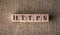 HTTPS word written on wooden blocks on a brown background