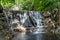 Huai Yang. Small waterfall with water motion in deep rain forest