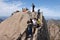 Huangshan Mountain in Anhui Province, China. Walkers with cellphones at the summit of Lotus Peak