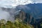 Huayna Picchu, or Wayna Pikchu, mountain in clouds rises over Machu Picchu Inca citadel, lost city of the Incas