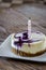 Huckleberry cheesecake with a candle