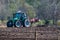 Hude, Germany April 6th, 2020: A tractor  stands with his implement on a freshly cleared field