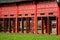 Hue, Vietnam, the imperial citadel. View of a palace corridor. Red door window shutters.