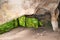 Huel Lee or Hohllay on the Mullerthal trail in Luxembourg, open cave with view to the forest, sandstone rock formation