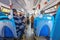 Huelva, Spain - April 9, 2022: Crowds of people inside a bus. Interior view of a municipal bus with passengers wearing protective