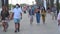 Huelva, Spain - July 4, 2020: People walking by Islantilla beach promenade wearing protective mask due to covid-19.