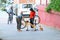 Huelva, Spain - May 8, 2020: The Father is fixing the bicycle of his daughter in the street for she can ride the bike during the