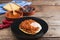Huevos rancheros Mexican breakfast on a wooden base. Mexican cuisine. Copy space