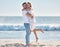 Hug, happy and couple at the beach for love, peace and relax on a tropical holiday in Hawaii. Freedom, travel and