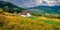 Huge ainbow at the summer rain. Panoramic morning view of Kvasy village, Transcarpathian, Ukraine.