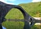 The huge arch of a humpback mediaeval bridge