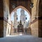 Huge arch revealing patio of Mamluk Sultan Al Nassir Qalawun mosque and two minarets, Cairo, Egypt