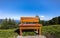 Huge bench agains idyllic alpine landscape with meadow, forest and blue sky in Tannheimer Valley, Tirol, Austria