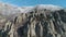 Huge and bizarre shapes of mountain rocks surrounded by snowed shrubs and trees against blue sky. Shot. Close-up.