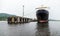 Huge black ferry ship is moored in port. Varna