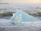 Huge blue iceberg against the waves on a windy day, Iceland