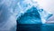 Huge blue iceberg with natural cave inside