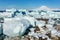 Huge blue icebergs driftingand laying ashore with Sermitsiaq mountain in the background, nearby Nuuk city, Greenland