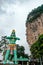 Huge blue statue of hindu god hanuman at entrance of batu caves during cloudy day in kuala lumpur malaysia