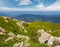 Huge boulders on a grassy slope in mountains