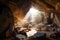 huge boulders and rubble filling the entrance of a mountain cave, with sunlight shining through