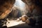 huge boulders and rubble filling the entrance of a mountain cave, with sunlight shining through