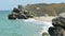 Huge boulders on sandy beach on sea island