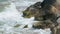 Huge boulders on shore of stormy sea, close-up