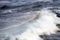 Huge breaking waves surge towards shore