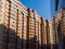 A huge brick residential building is reflected in a glass wall