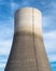 A huge chimney of a nuclear power plant close up on a background of blue sky with clouds, with clipping path.