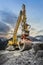huge clamshell grab excavator for natural stone masonry in front of alp mountains