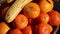 Huge closeup on mandarin oranges, bananas, apples, fresh fruit in bowl on balcony,