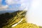 A huge cloud envelops the green Carpathian mountains