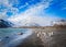 Huge cloud of katabatic winds looms over shoreline with king penguins