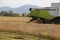 Huge Combine harvesting during cereal harvesting in the cultivat