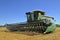 Huge combine parked in wheat field