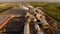 A huge concrete plant with pipes among the fields. aerial view