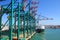 Huge container handling gantry cranes at a container terminal. Cargo ship and Blue sky background