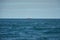 Huge container tanker ship carrying truck size containers in deep blue open ocean sea.