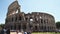 Huge crowd of tourists near ancient Colosseum amphitheater, travel to Rome