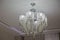 Huge crystal chandelier in the hall . White lamp in the large meeting room