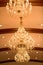 Huge crystal glass chandeliers hanging on ballroom dance in wedding ceremony date,decorated by victorian style.