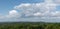 Huge cumulonimbus cloud above hilly countryside